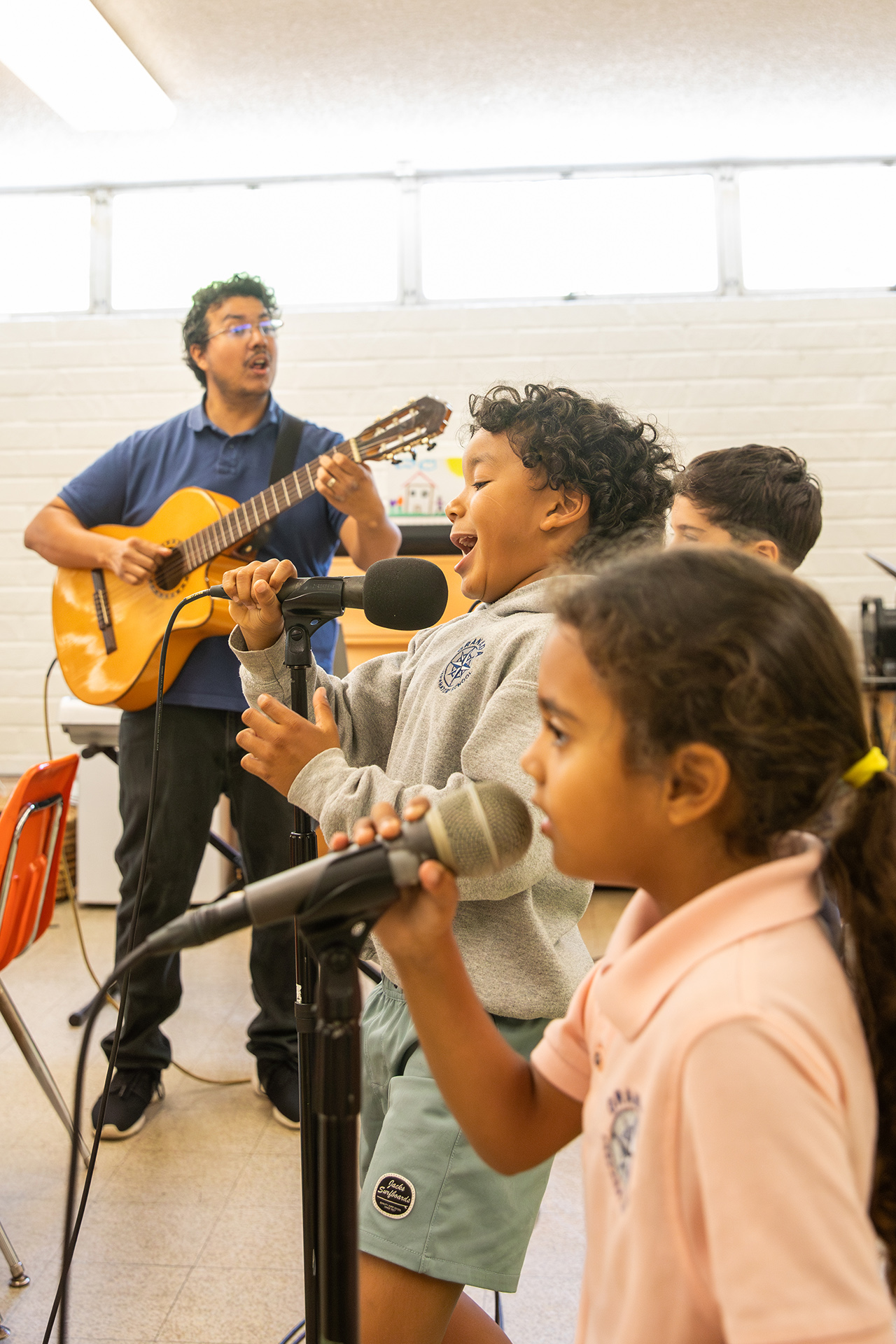 Music ensemble singing with guitar accompaniment